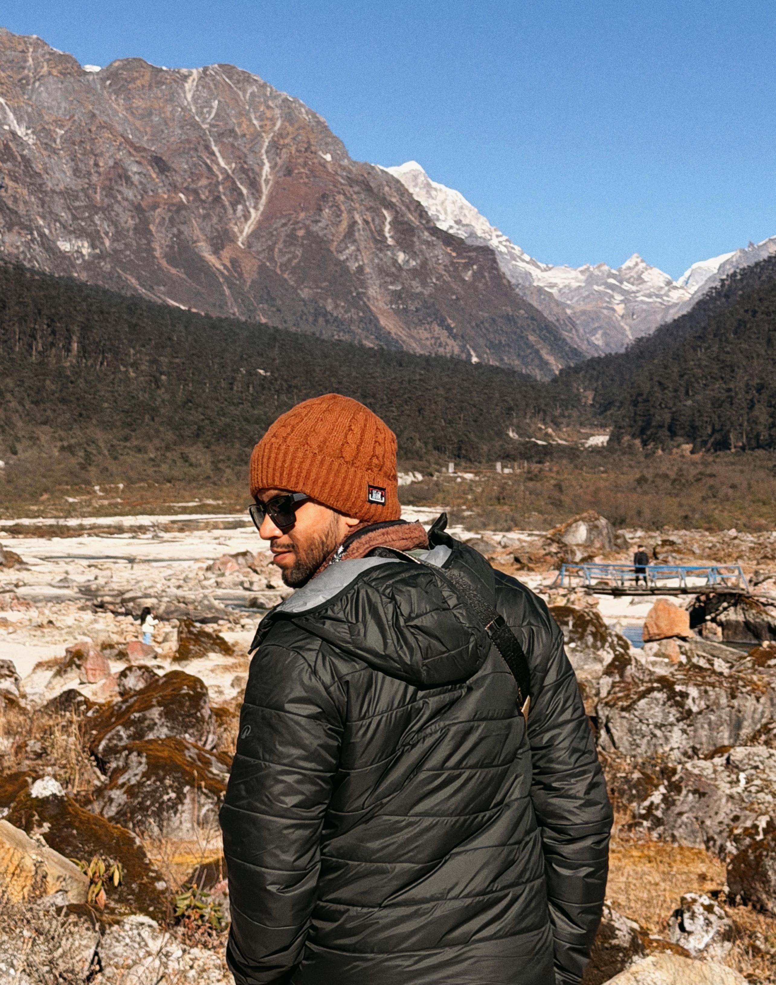 Muhammed Jaseem standing in front of a mountain landscape.